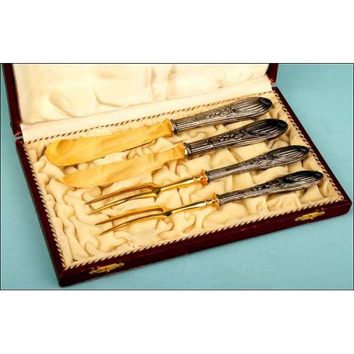 Case with four silver and gold flatware