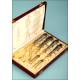 Case with four silver and gold flatware