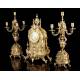 Antique set of mantel clock and pair of candlesticks. France, 19th Century