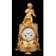 Delicate Mantel Clock in Gilded Bronze with Cupid. France, XIX Century