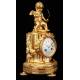 Delicate Mantel Clock in Gilded Bronze with Cupid. France, XIX Century