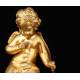 Delicate Mantel Clock in Gilded Bronze with Cupid. France, XIX Century