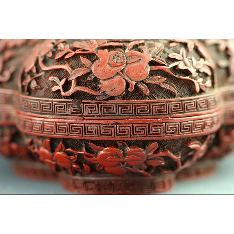 Chinese Box Lacquered in Red and Carved all over its surface. Restoration